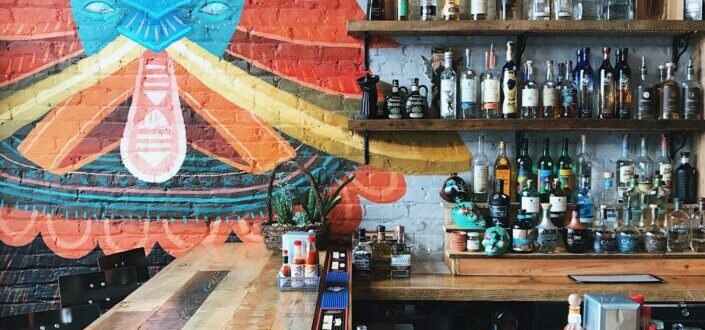 Assorted Alcoholic Bottles on Wooden Rack