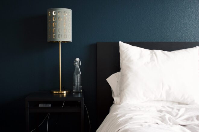 Lamp beside a white bed with pillows - Hotel Calimala - Florence Italy