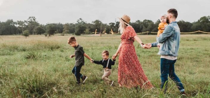 Family Running Through the Field
