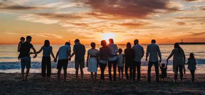 People Standing on Shore During Golden Hour