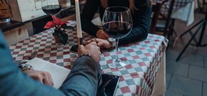 Man Holding a Woman's Hand on Table