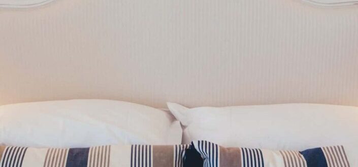 White and Blue Pillows on a Bed