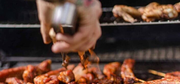 Person is Cooking Meat on a Grill