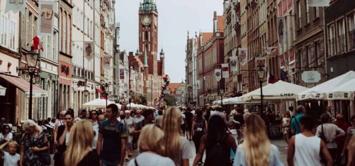 Brown Clock Tower in a Sea of People