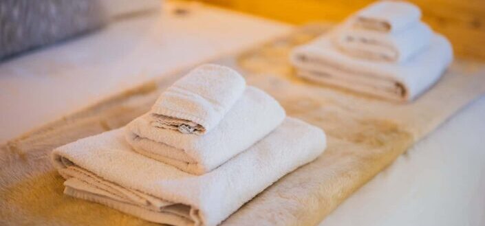 Bedroom in a Wooden Interior With Towels