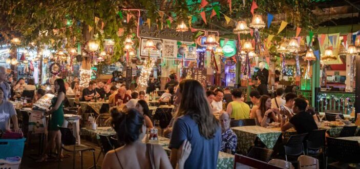 People in an Open Air Restaurant at Night Time