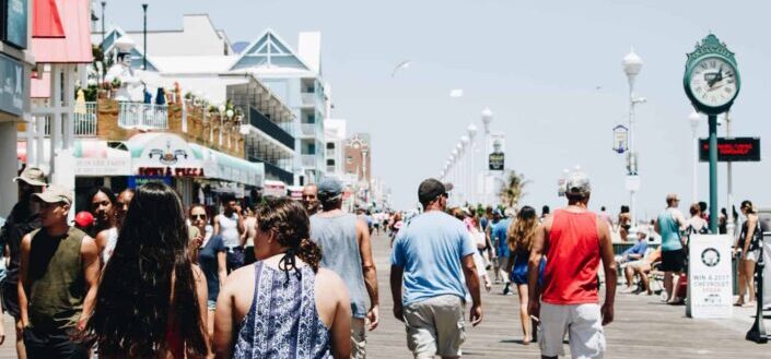 Walking Tourists on Vacation By the Beach